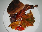Tandoori chicken with BBQ d red onion and peppers  toasted pitta bread  mushroom and green bean bhaji