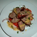 Toulouse sausage with a tomato caper and shallot salad