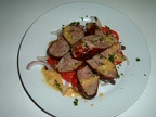 Toulouse sausage with a tomato caper and shallot salad