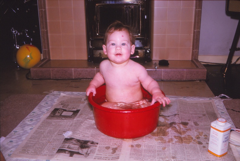 27 9.5 months having bath in the red bowl.jpg